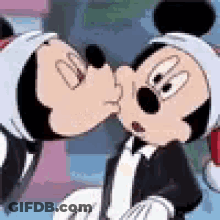 Mickey Mouse And Minnie Mouse Kissing Each Other In A Cartoon . GIF