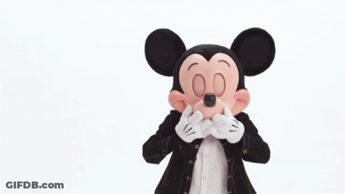 Mickey Mouse Is Wearing A Black Jacket And Red Shorts GIF