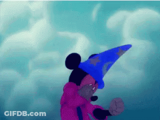 Mickey Mouse Is Wearing A Blue Wizard Hat And A Pink Robe GIF