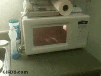 Microwave Oven Next To Soap And Paper Towels GIF