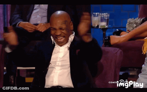 Mike Tyson Is Sitting On A Couch With His Arms Up GIF
