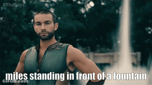Miles Standing In Front Of Fountain GIF