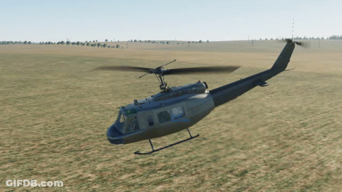 Military Helicopter Flying Over Grassy Field GIF