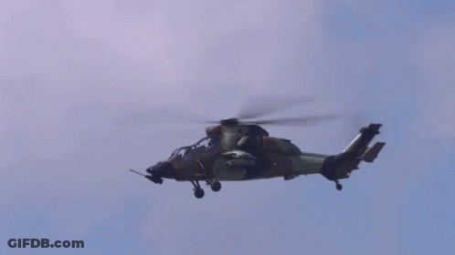 Military Helicopter Flying Through Blue Sky GIF