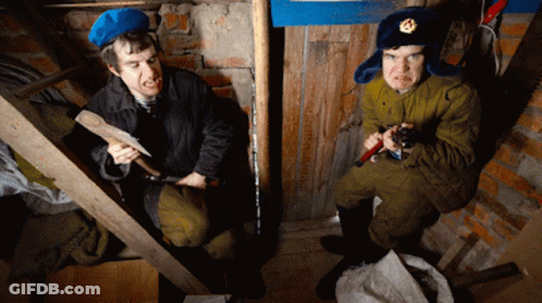 Military Man Holding Hammer And Man With Saw GIF