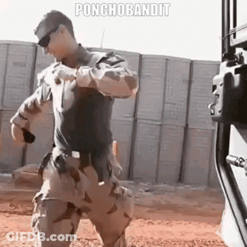 Military Man Standing Before Ponchobandit Wall GIF