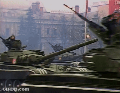 Military Tanks Driving Past Red CNN Building GIF