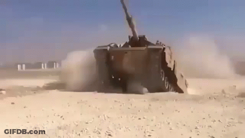 Military Vehicle Driving Through Desert GIF