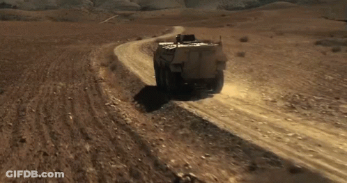 Military Vehicle On Desert Dirt Road GIF