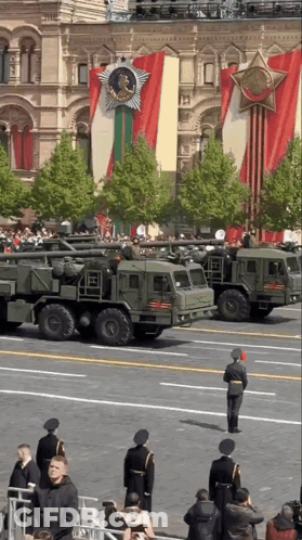 Military Vehicles Parked In Front Of Building GIF