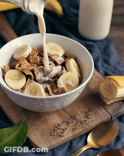 Milk Is Being Poured Into A Bowl Of Cereal GIF