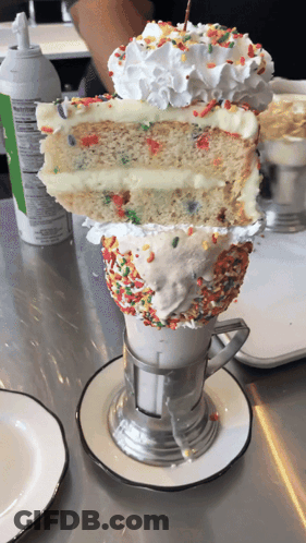 Milkshake With Cake Slice And Sprinkles GIF
