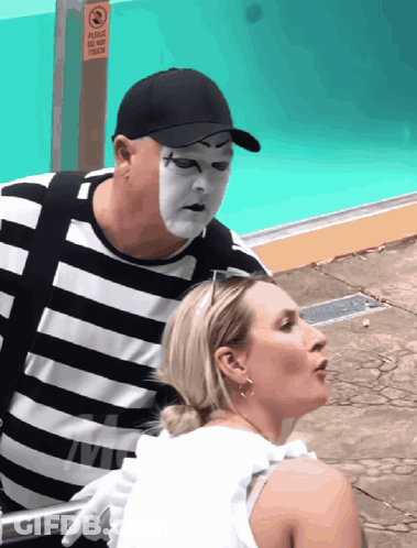Mime Masked Man Next To Woman By Pool GIF