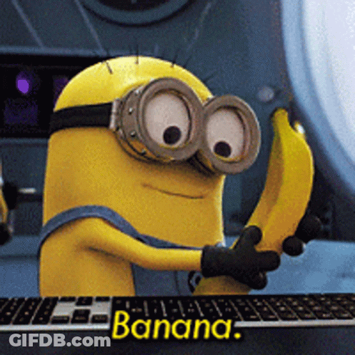 Minion Holding Banana In Front Of Keyboard GIF
