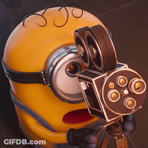 Minion Holding Camera With Number 80 GIF