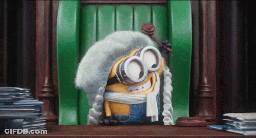 Minion Wearing Wig And Goggles Sitting GIF