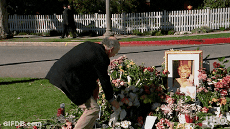 Mischievous Guy Stealing Flower From Funeral GIF