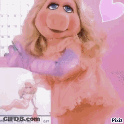 Miss Piggy From The Muppets Is Wearing A Pink Dress And Gloves And Is Standing In Front Of A Calendar . GIF