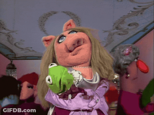 Miss Piggy Is Holding A Green Kermit The Frog In Her Arms GIF
