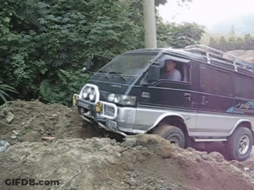 Mitsubishi Van Driving Through Pile Of Dirt GIF