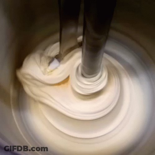 Mixer Mixing White Substance In Container GIF