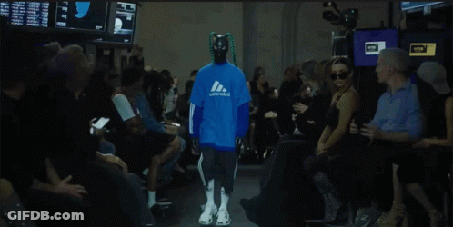 Model Walking Down Runway In Blue Adidas Sweatshirt GIF