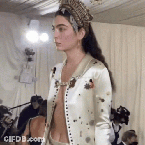 Model Walking Runway In Crown And Revealing Jacket GIF