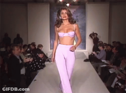 Model Walking Runway In Purple Pants And Bra GIF