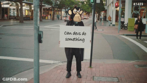 Monkey Holding Sign Saying Can Devs Do Something GIF