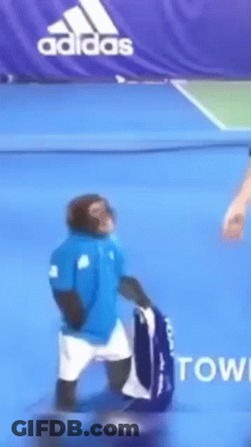 Monkey In Blue Shirt Holding Tennis Racket GIF
