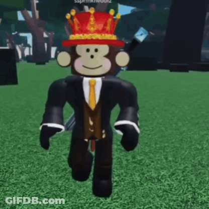 Monkey In Suit And Tie With Crown Walking On Grass GIF