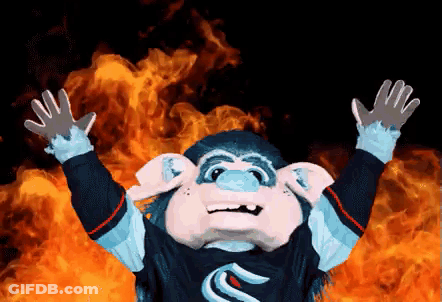 Monkey Mascot Standing In Front Of Fire With Arms Outstretched GIF