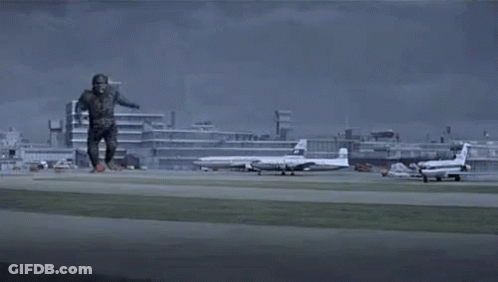 Monster Running On Runway In Front Of City GIF