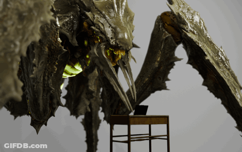 Monster Statue Standing Beside Desk With Laptop GIF