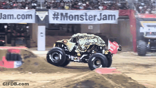 Monster Truck Driving Down Dirt Track In Front Of Monster Jam Banner GIF