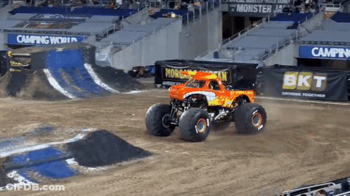 Monster Truck On Dirt Track Near BKT Sign GIF
