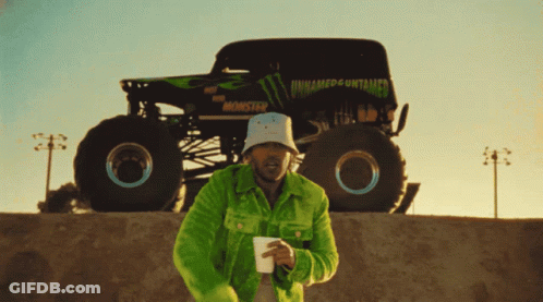 Monster Truck On Dirt Track With Toughest Sign GIF