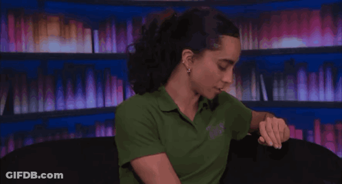 Morgan Veto Holder Holding Glass By Bookshelf GIF