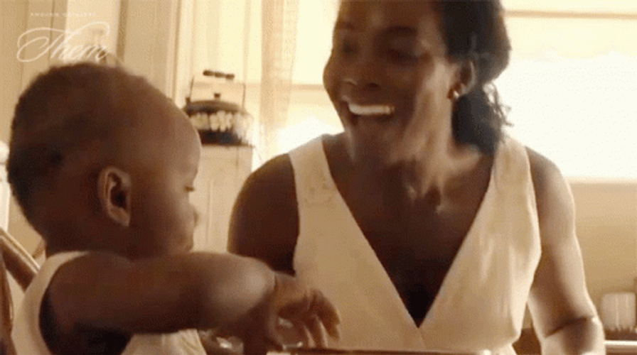 Mother Forehead Kiss To Her Playing Son GIF