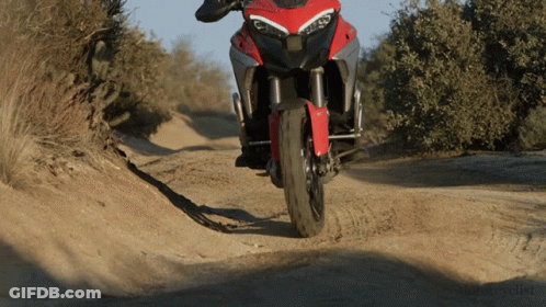 Motorcycle Driving Down Dirt Road Saying Motorcycle GIF
