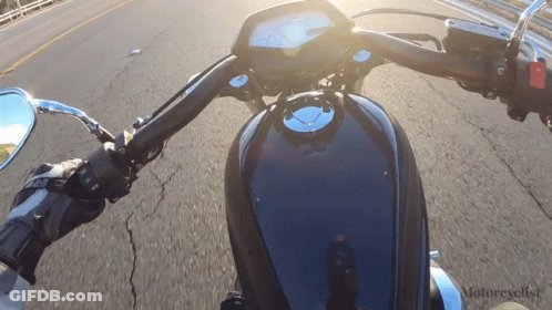 Motorcycle Driving Down Road With Motorcyclist Text GIF