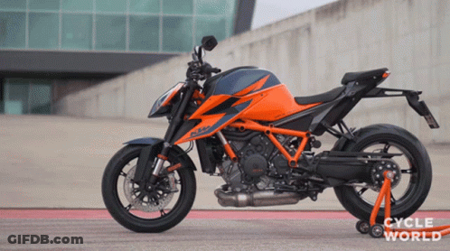 Motorcycle Parked In Front Of Cycle World Building GIF