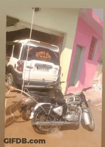 Motorcycle Parked In Front Of White SUV With License Plate J07 DF 6113 GIF