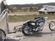 Motorcycle Pulled By Trailer On Side Of Road GIF