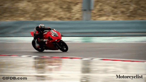 Motorcyclist Riding Red Motorcycle On Wet Track GIF
