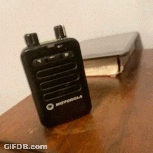 Motorola Walkie Talkie Next To Book GIF