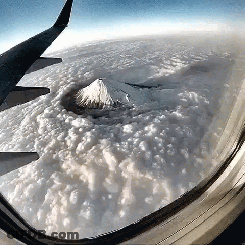 Mountain View From Airplane Window With Clouds GIF