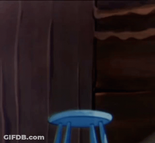 Mouse In Diaper Holding Dunce Towel On Blue Stool GIF