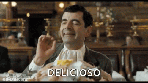 Mr Bean Eating Hamburger At Table GIF