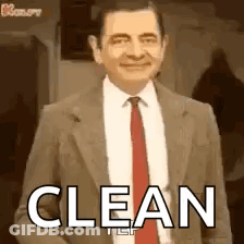 Mr Bean In Suit And Tie Smiling Saying Clean GIF